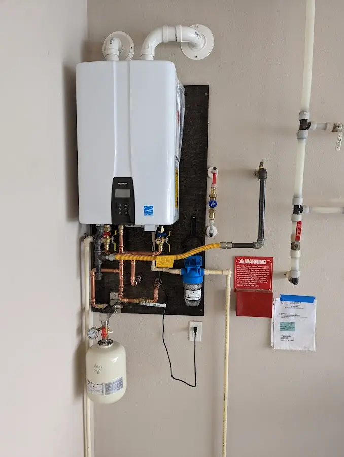 Professional plumber installing copper piping in a Pittsgrove home